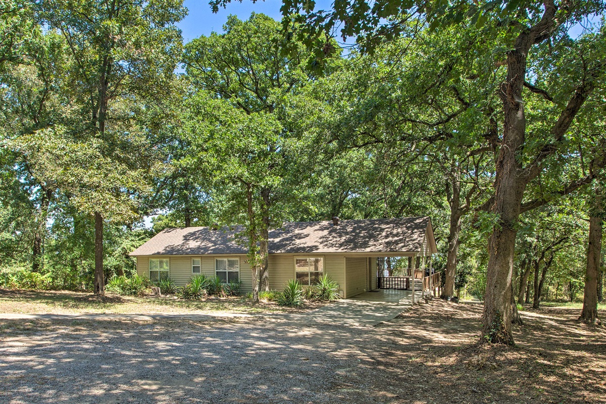 Driveway with main entrance at carport.