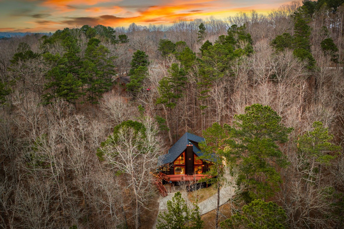Towering trees frame the property, adding both privacy and a sense of tranquility.
