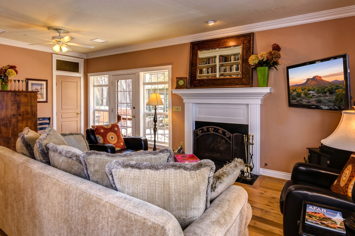 This expansive living room offers plenty of space for everyone to spread out and relax. Whether you're curling up by the fire with a good book, watching a movie on the  60-inch Smart TV, or enjoying game night with friends, this space has it all