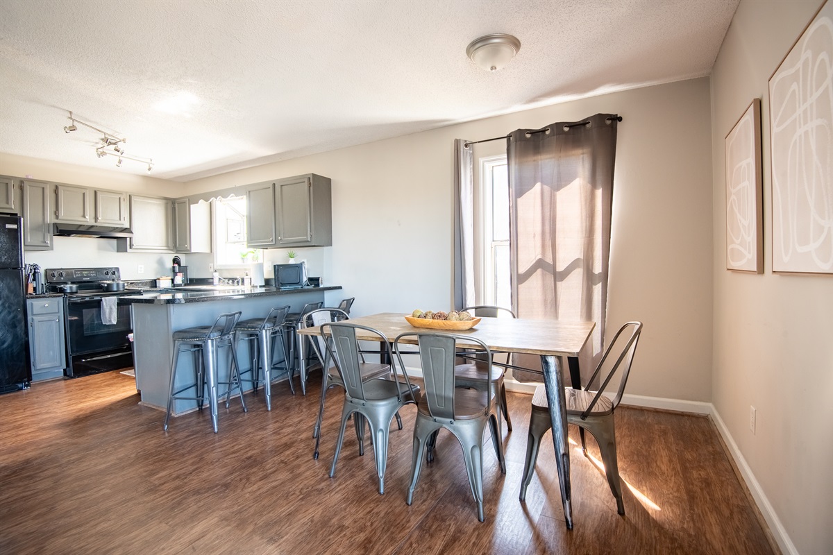 Unit F's dining space has plenty of seating with 6 chairs total and 4 bar seats. Great for a group card game or family meal together!