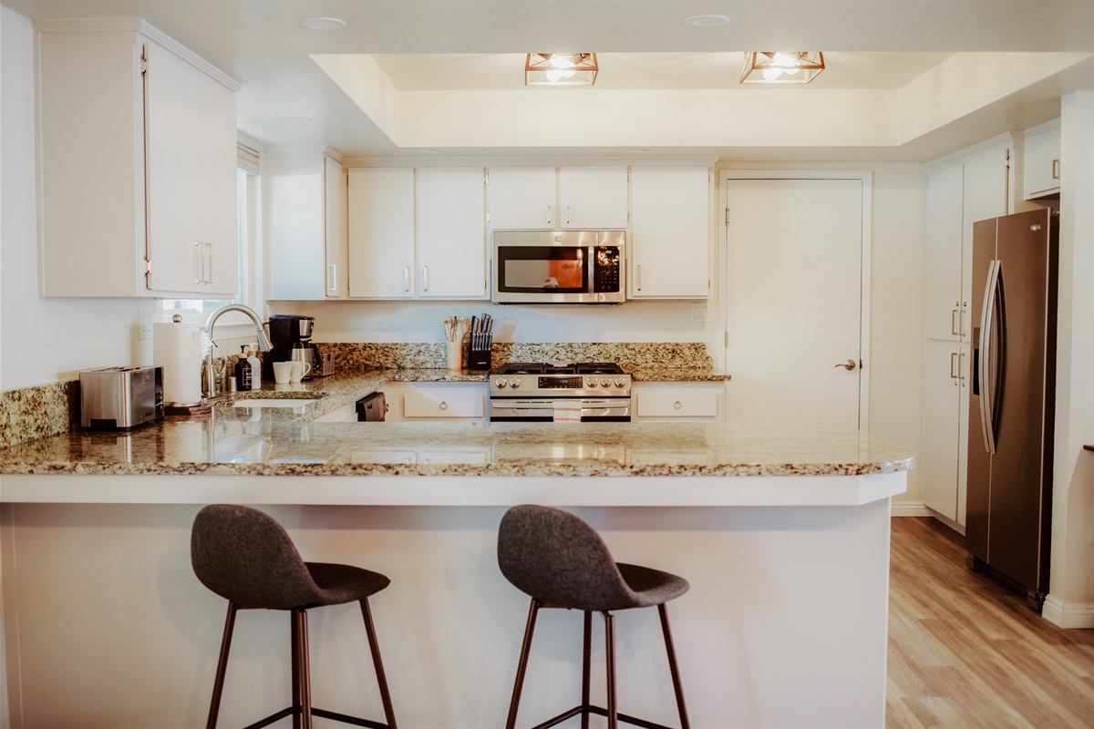 Stylish gourmet kitchen with breakfast bar seating.