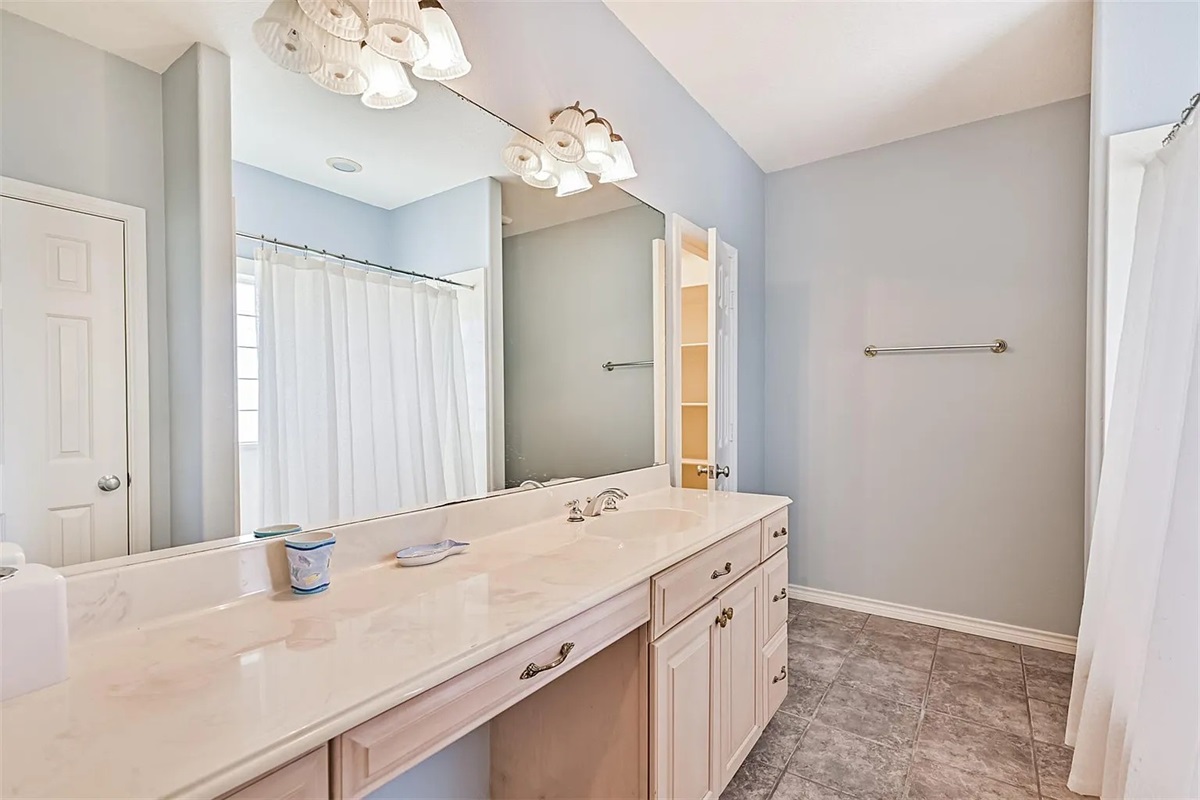 The second Primary Ensuite Bathroom with jetted tub, shower, and vanity