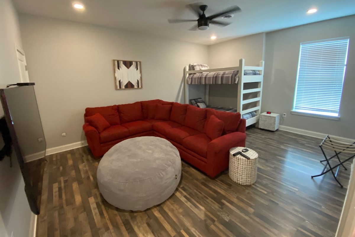 Large kid room/2nd living room with 2 twin bunk beds.