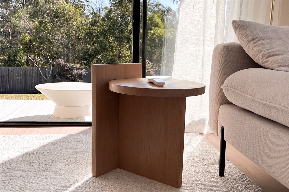 The garden outlook brings the reserve backdrop into the lounge, giving this corner a calm indoor-outdoor feel.