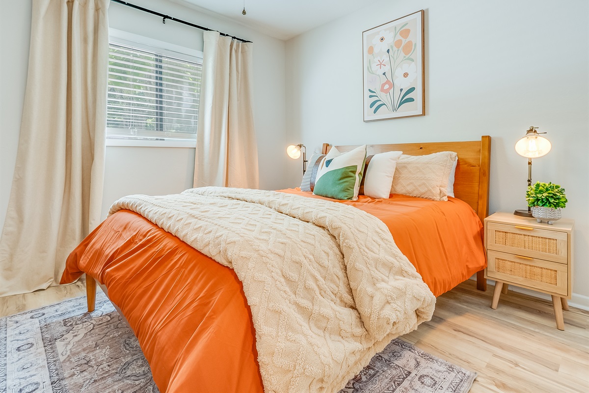 A bright and welcoming bedroom with a comfortable queen bed—perfect for unwinding after a day out.