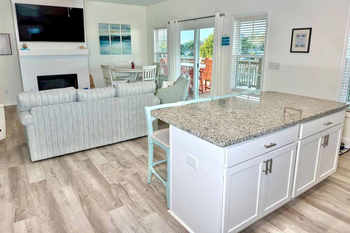 Enjoy cooking in this fully stocked kitchen with an island, bar seating, and a water view.