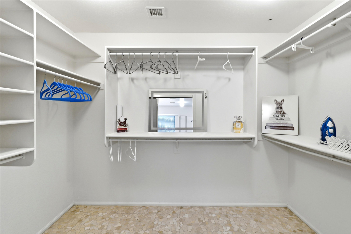 Walk-in closet with hanging space, shelves, and room to unpack during your stay.
