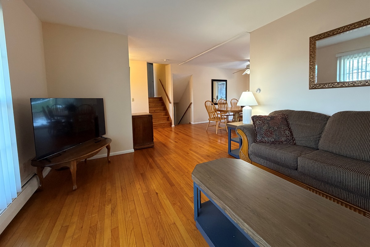 Living room with SmartTV, stairs up and down