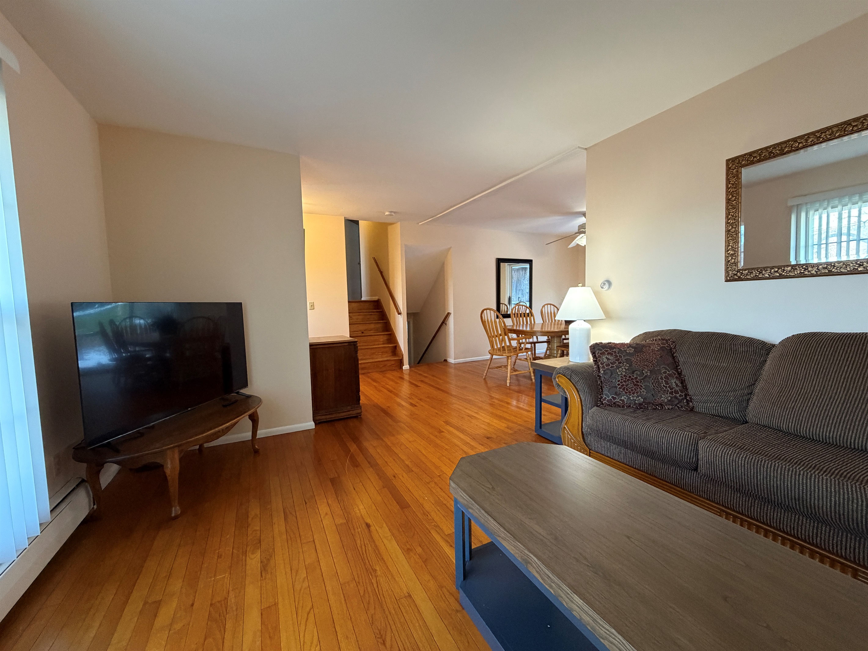 Living room with SmartTV, stairs up and down