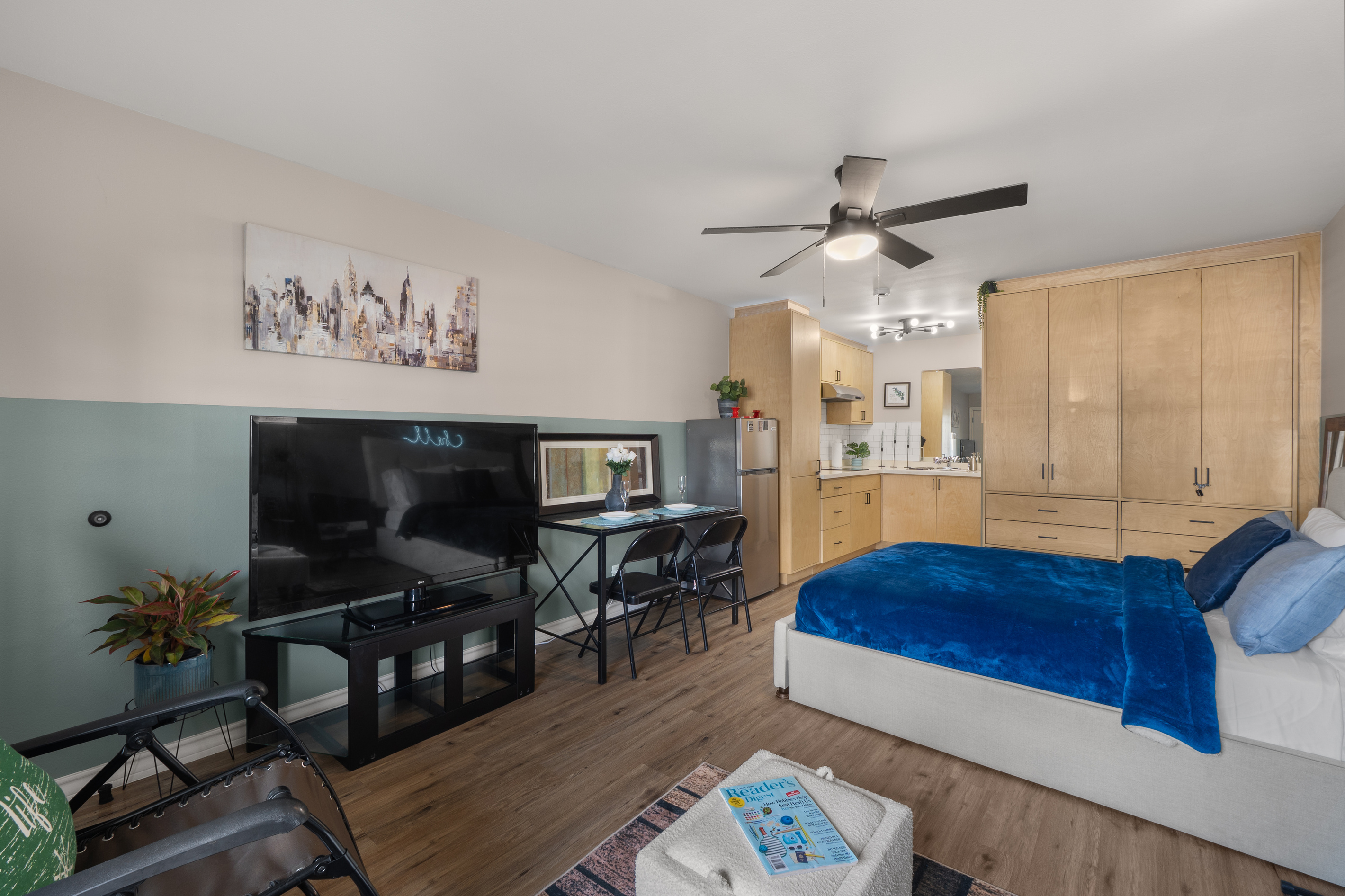 Studio view with the bed, TV, dining spot, kitchenette, and storage all in one easy space.
