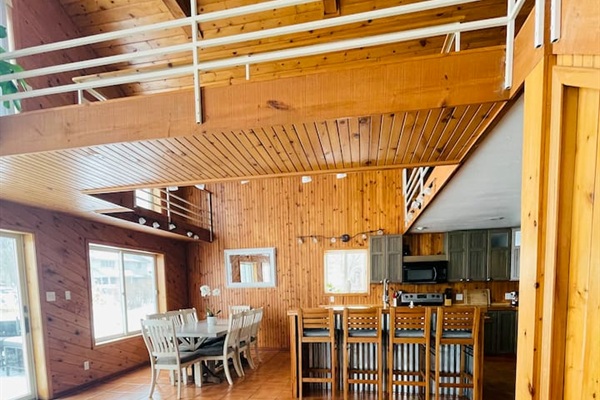 Spacious open-concept living and dining area with vaulted ceilings.
