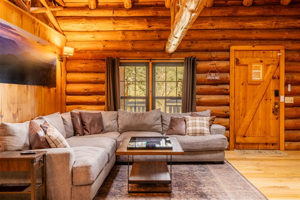 Spacious sectional sofa and warm wood interiors create the perfect spot to relax after a day of adventure.