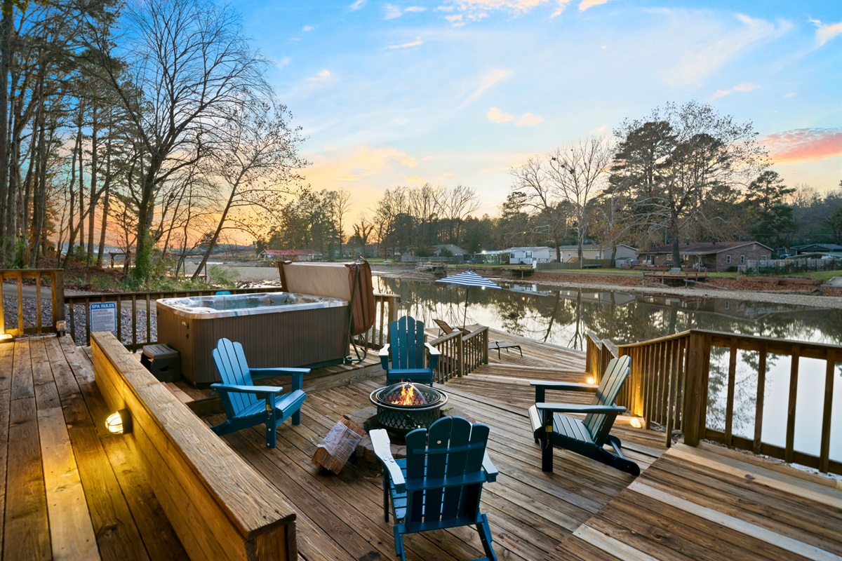 As the sun sets, the firepit area transforms into a cozy evening hangout with a warm glow and beautiful views reflecting off the lake.