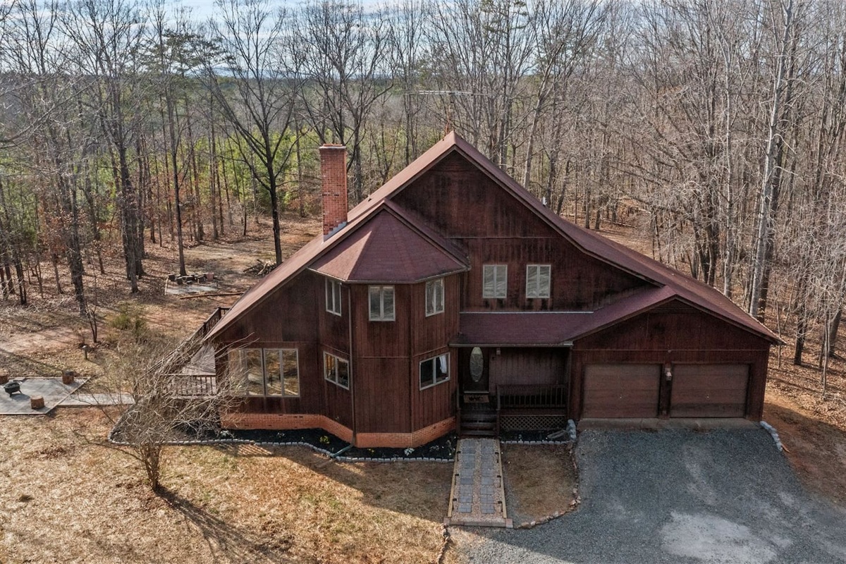 Charming Getaway: Nestled among trees, this unique home blends rustic charm with modern comfort!