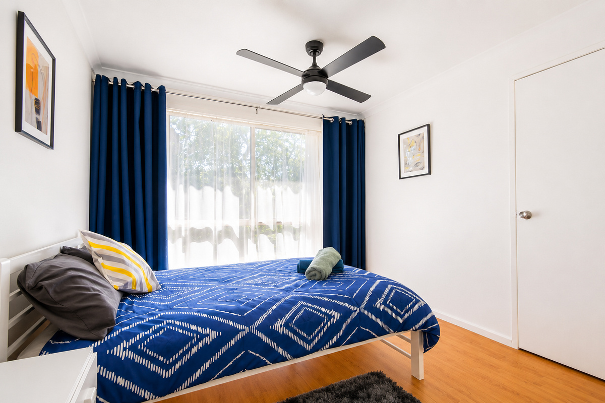 1 Queen bed Bedroom - The queen bedroom at Carlenes Getaway has natural light, a ceiling fan and simple comfort for a restful Loch Sport stay.
