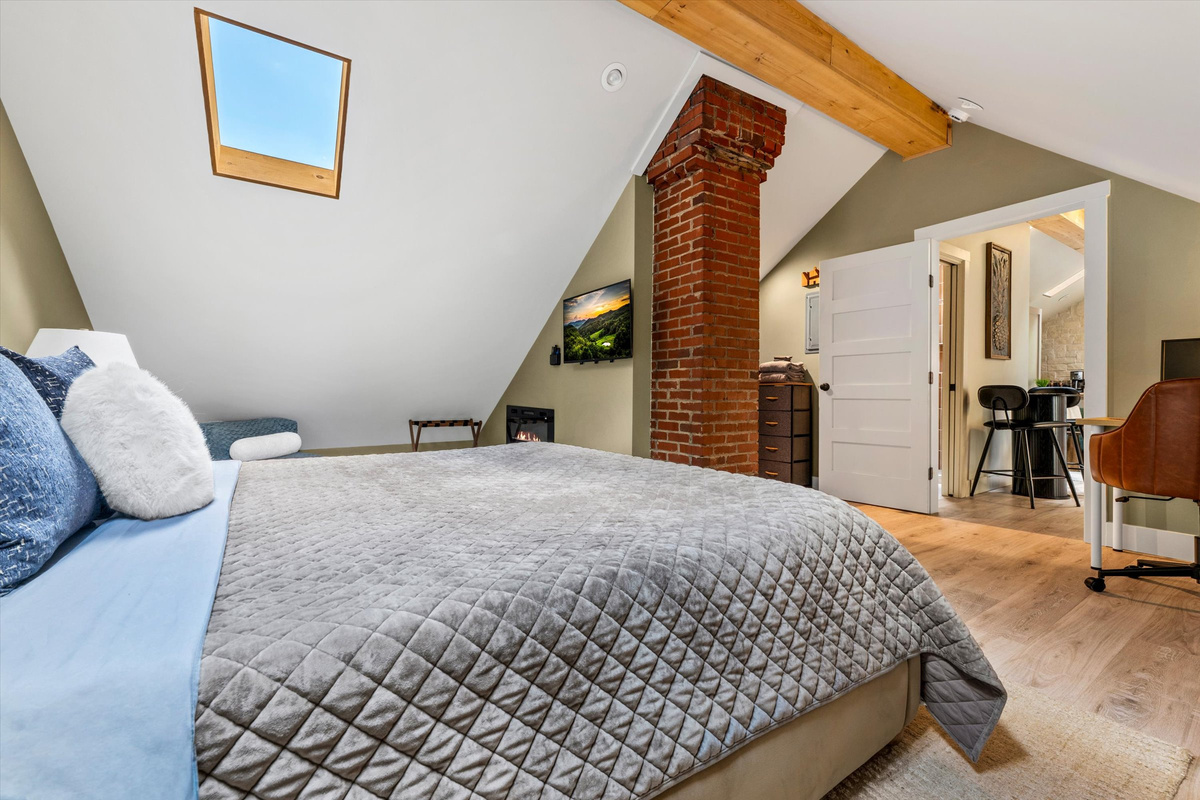 Master Bedroom with King Bed, 42-inch Smart TV, Fireplace, sound machine, blackout curtains and cozy reading chair