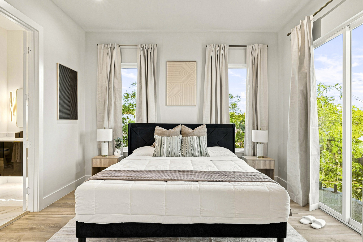 Bright and airy retreat with elegant decor and views of lush greenery. Perfect for relaxation!