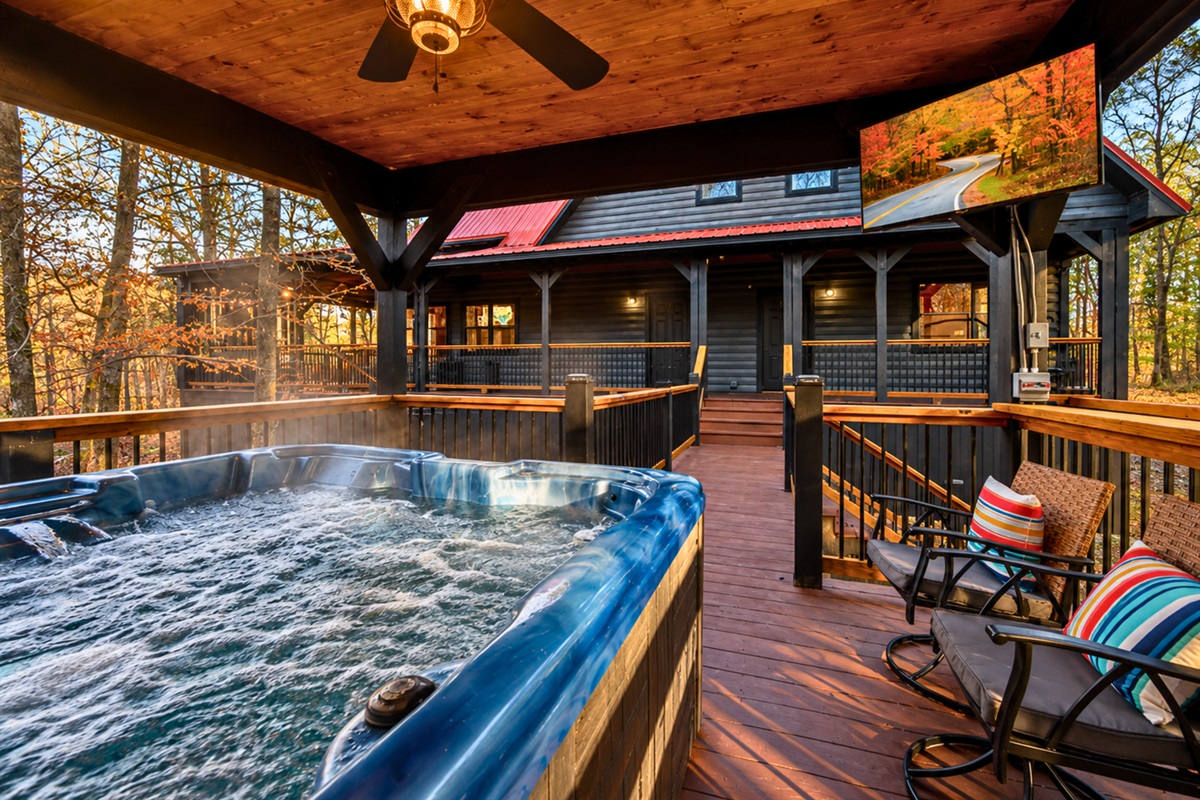 Tucked beneath the covered deck, the bubbling hot tub creates the perfect place to unwind after a day spent outdoors.