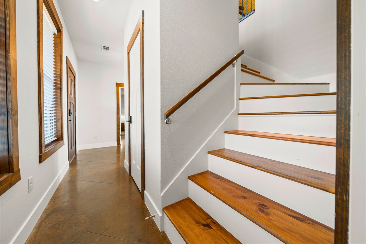 The bright hallway and staircase connect the home beautifully, guiding you effortlessly between each thoughtfully designed space.
