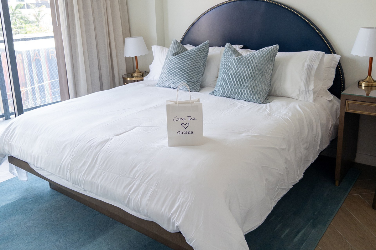 The king bed is dressed in layered, hotel-quality linens for that first unforgettable nights sleep.