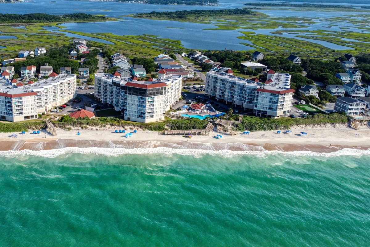 Oceanfront resort framed by sea and marsh views