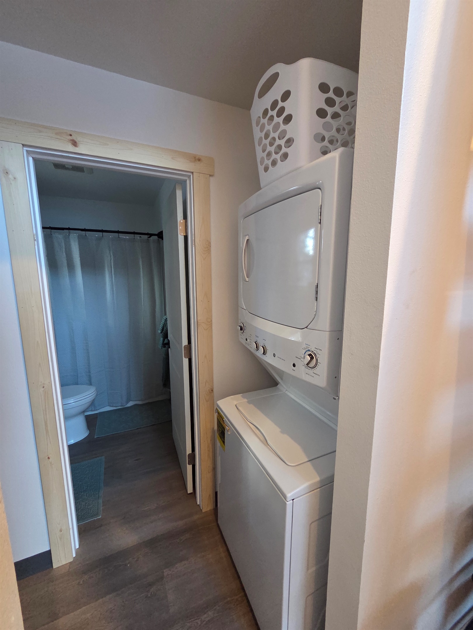 Laundry room with stacked washer / dryer located just outside bathroom [Photo is representative but is not from this cabin].