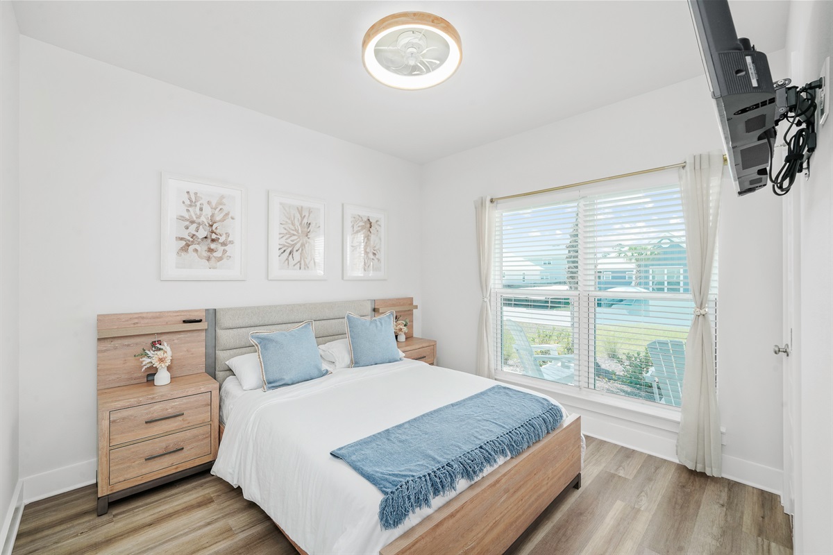 Bedroom 2: Bright Queen bedroom, comfy linens, ceiling fan, elegant bedside lamps, wall art, and Smart TV.