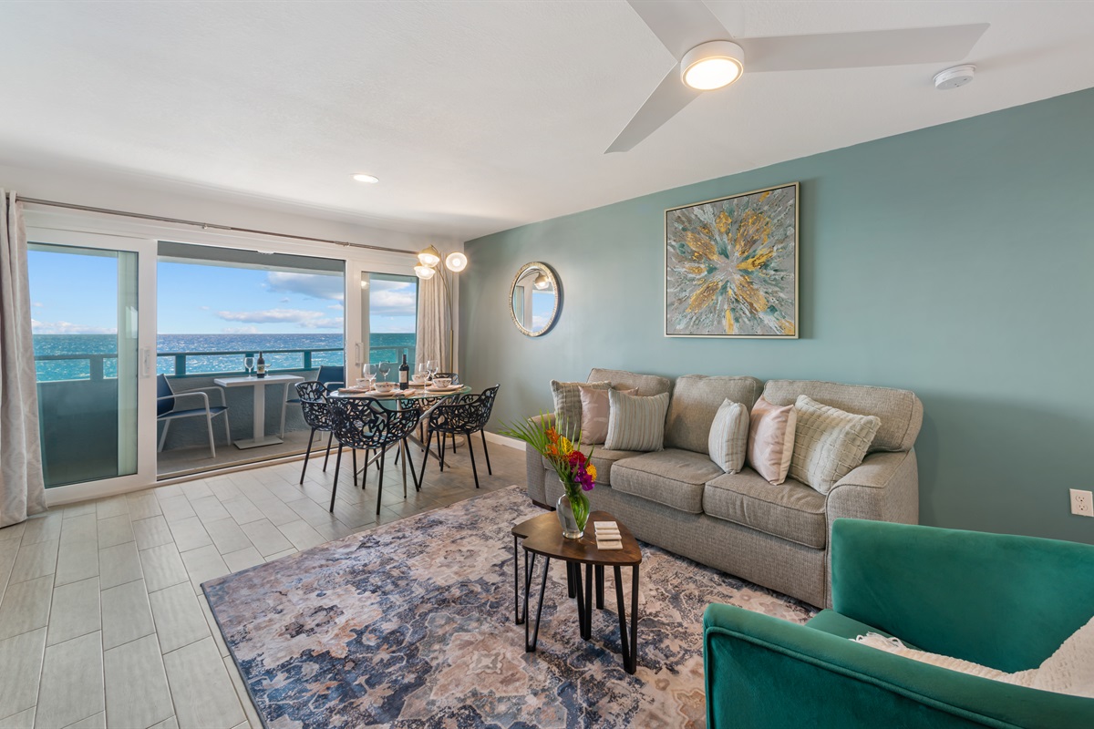 Large living room with sleeper sofa and dining area which opens to balcony