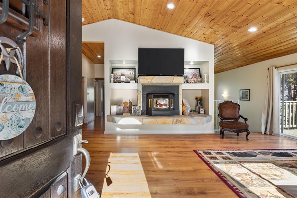 A warm welcome at the front door, with a sneak peek into the cozy living room waiting inside.