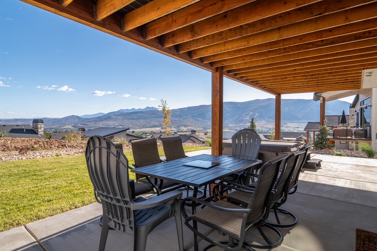 Covered patio seating with stunning mountain scenery.