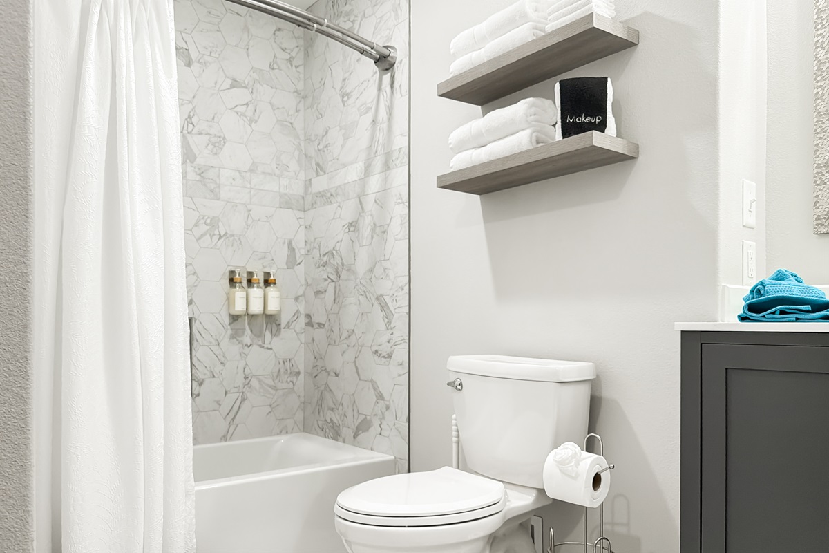 The bathroom has a shower/tub combo.