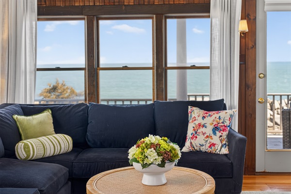 Relax in a bright, cozy living room with beautiful ocean views and coastal charm. 🌊