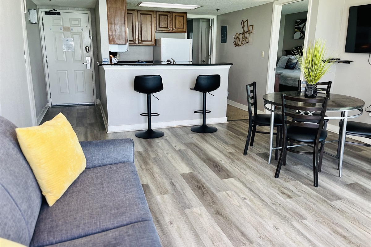 Experience open-air comfort in the living area, where the sliding glass doors bring in the coastal breeze, creating a refreshing and inviting space.