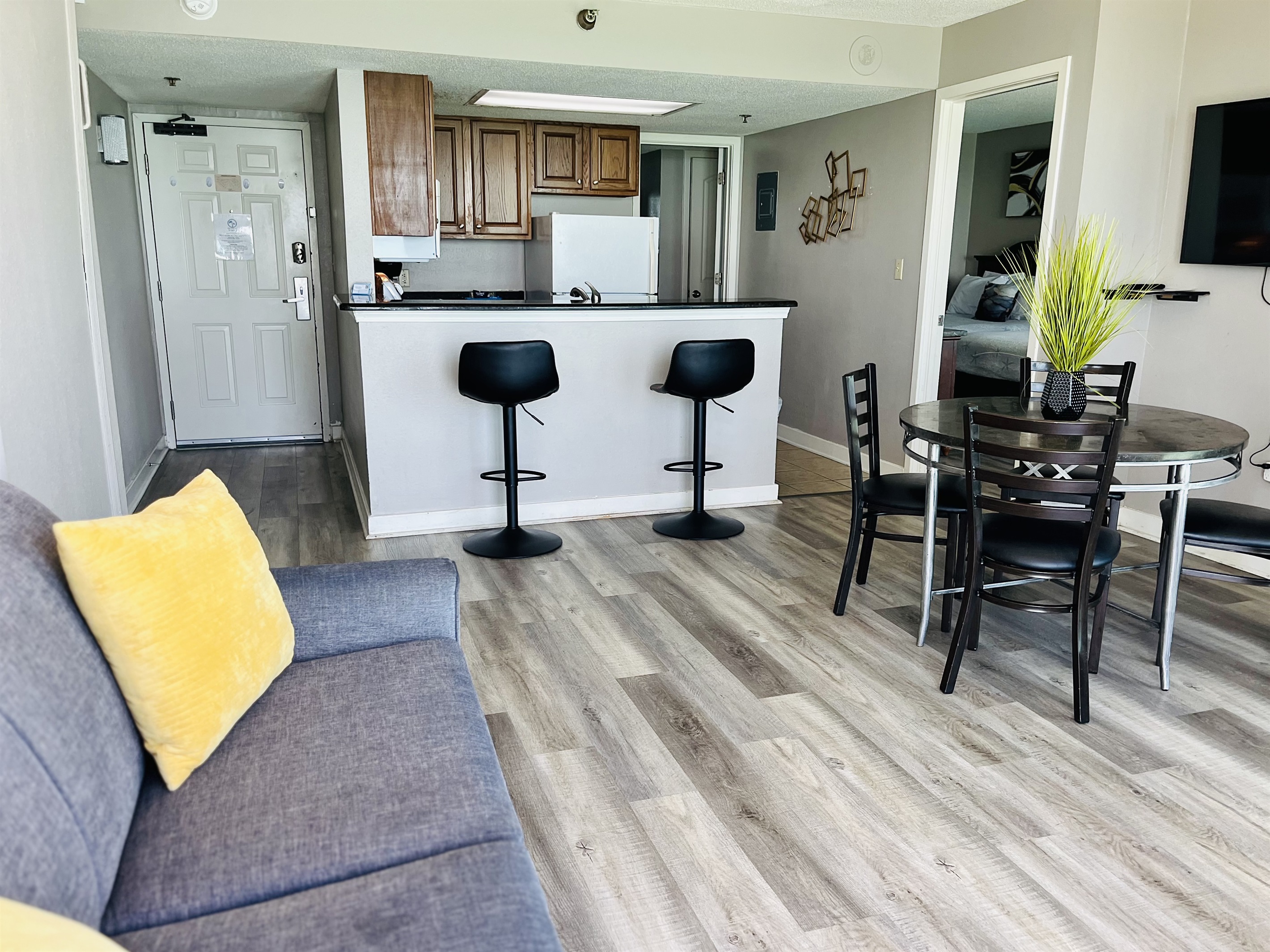 Experience open-air comfort in the living area, where the sliding glass doors bring in the coastal breeze, creating a refreshing and inviting space.