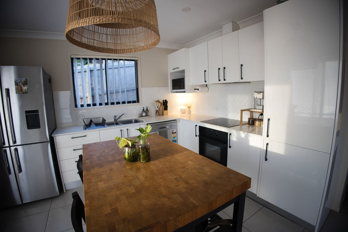 Full kitchen with a big fridge, pots, pans, coffee machine, stove top, oven, dishwasher, microwave, utensils  and everything you need to cook whatever you like so you feel right at home