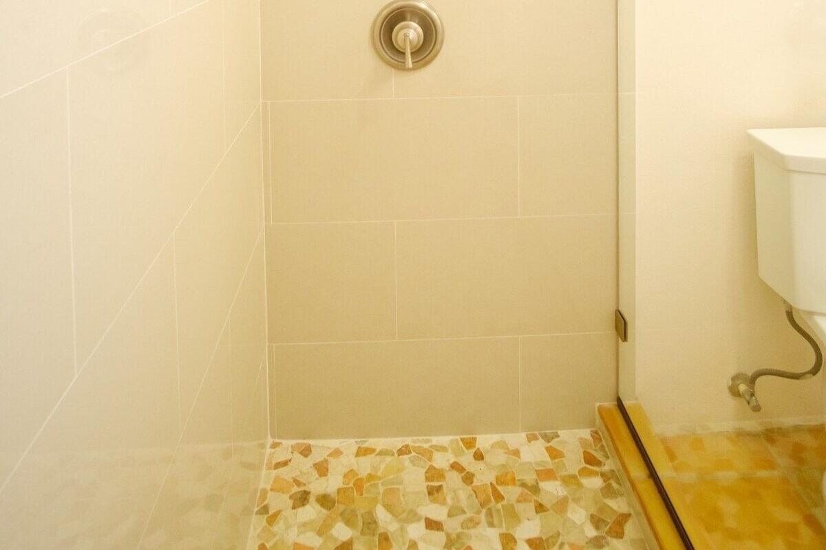 Please do not rinse sand down the drain. Use the hose at the entrance.