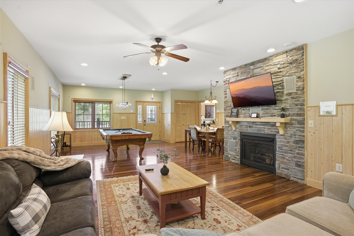 Unwind in the spacious living room with cozy couches, a gas fireplace, and a large TV for movie nights. Step right out to the back porch to enjoy some fresh air and keep the good vibes going.