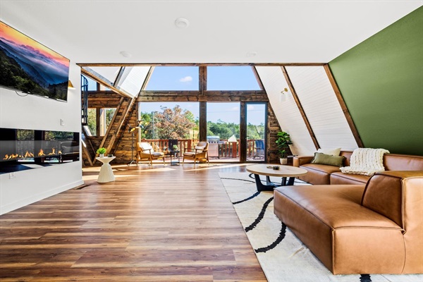 Living Room: Bright, airy space with modern decor, stunning views, and a warm fireplace!