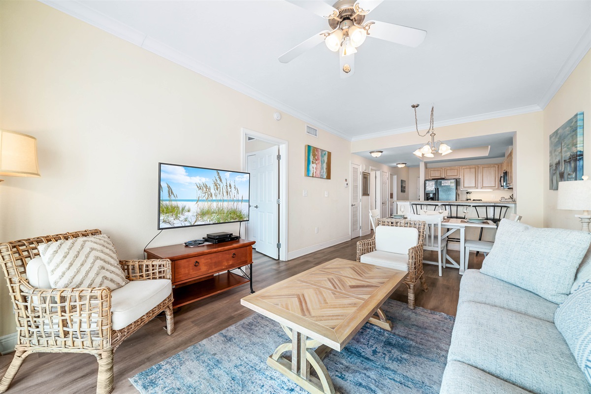 A comfortable living room with ample seating, flowing into a dining area, ideal for everyday living and gatherings.