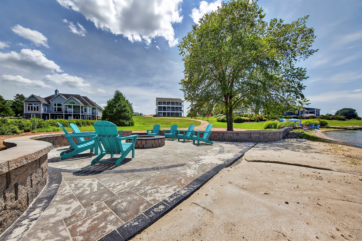 Gather around the custom stone firepit as the sun sets, with panoramic lake views and cozy Adirondack seating for the perfect evening by the water.