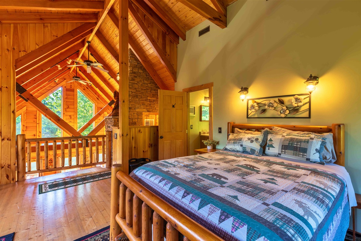 This bedroom has lots of natural lighting coming from the grand windows!