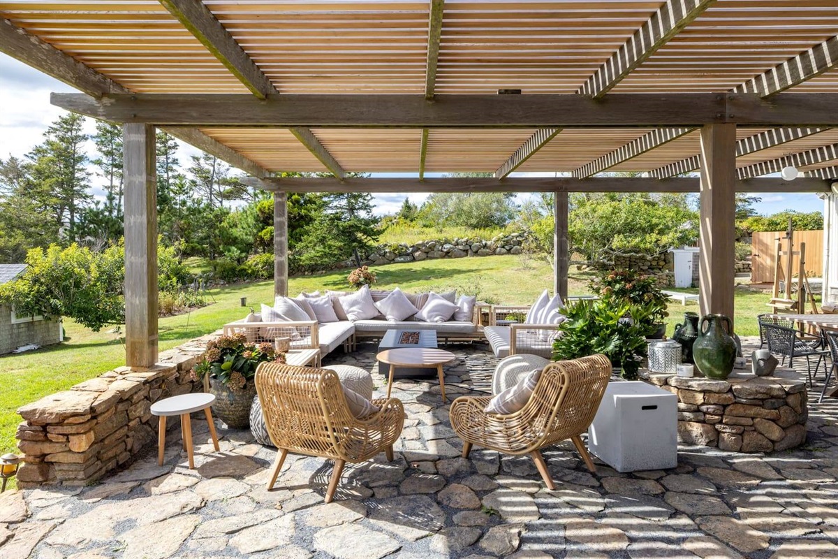 MAIN HOUSE: outdoor lounging area with gas fire table and outdoor dining table on the right