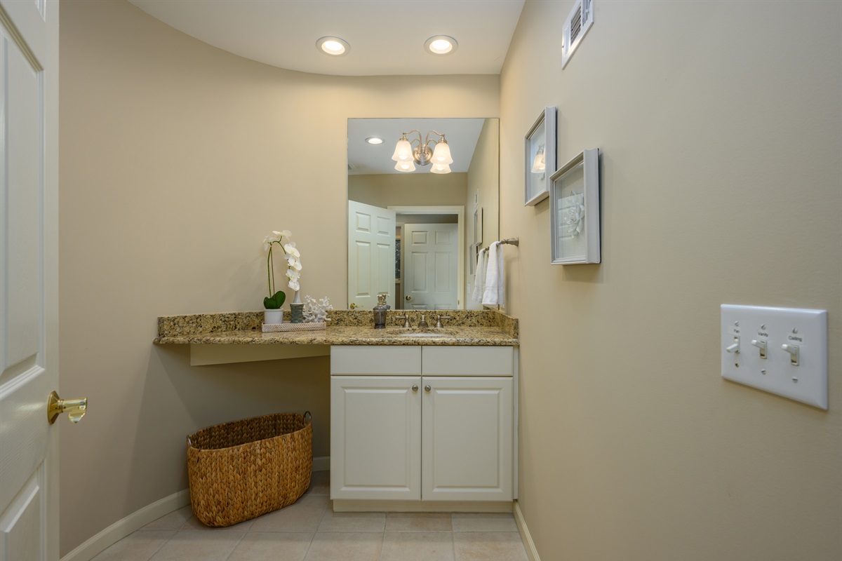 Guest half bath off kids den area and across from laundry room