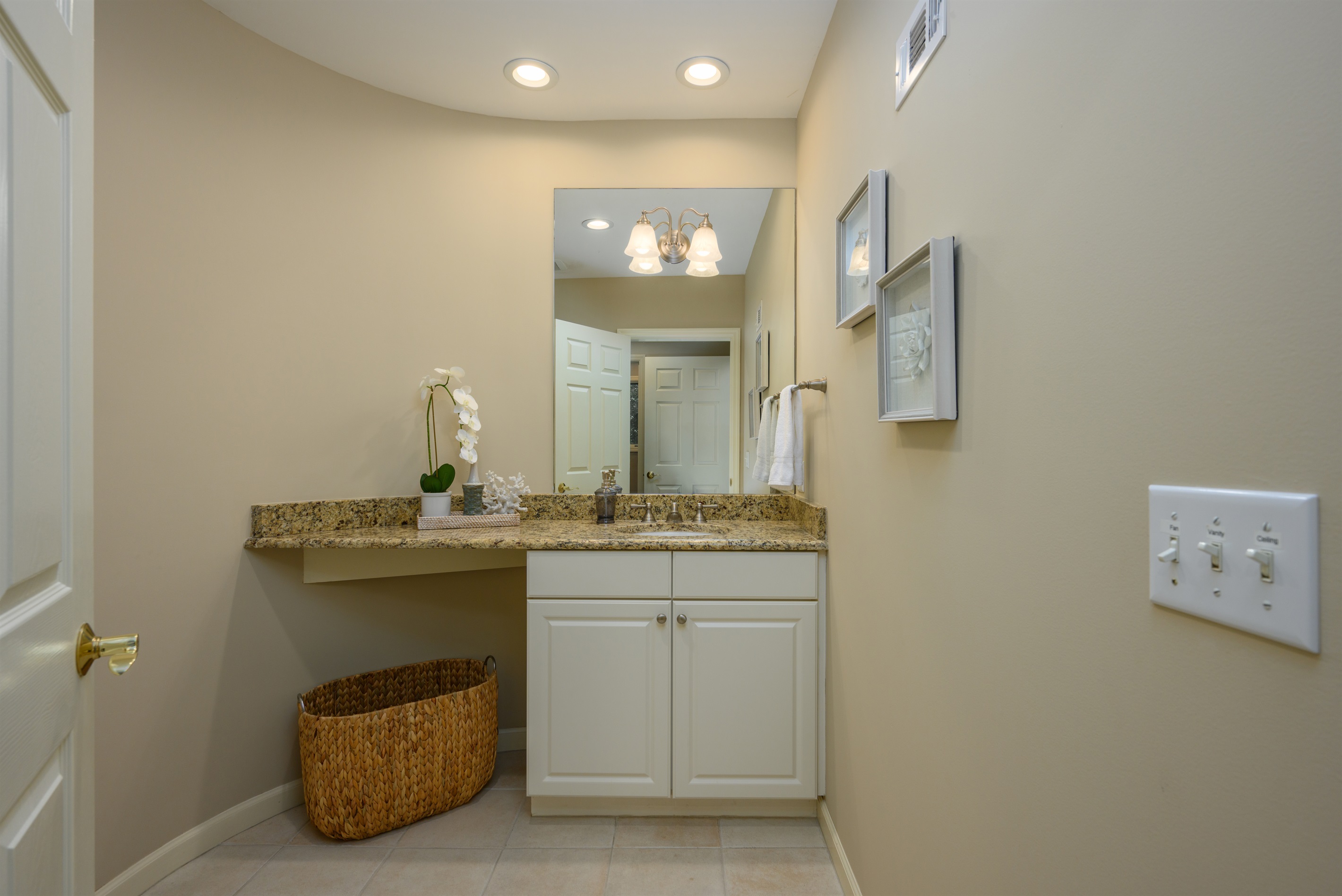 Guest half bath off kids den area and across from laundry room