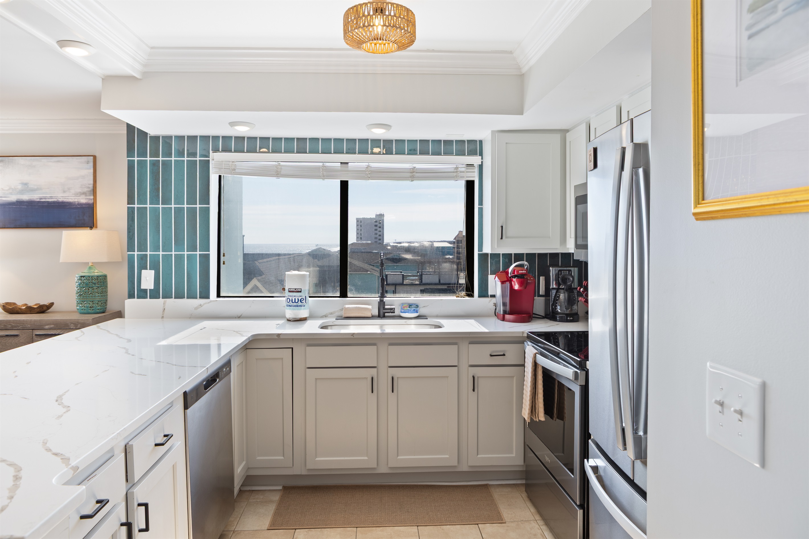 Well stocked kitchen with full size fridge, range oven, microwave, and dishwasher