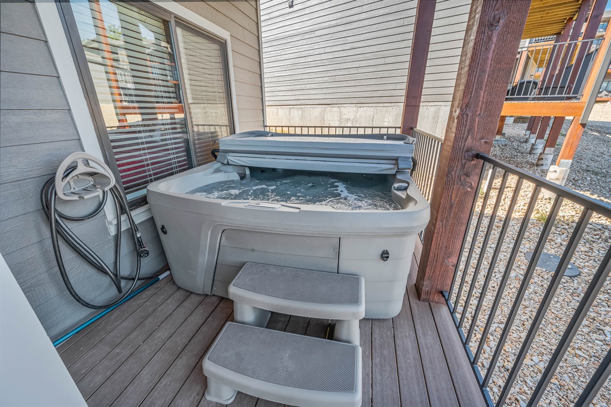 Private hot tub on the lower deck with a full size fridge for extra food and drinks