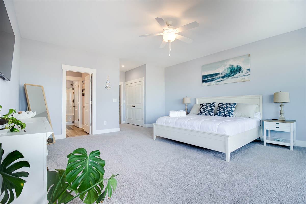 Light-filled and airy with a ceiling fan, calming colors, and plenty of room to unwind after a day out