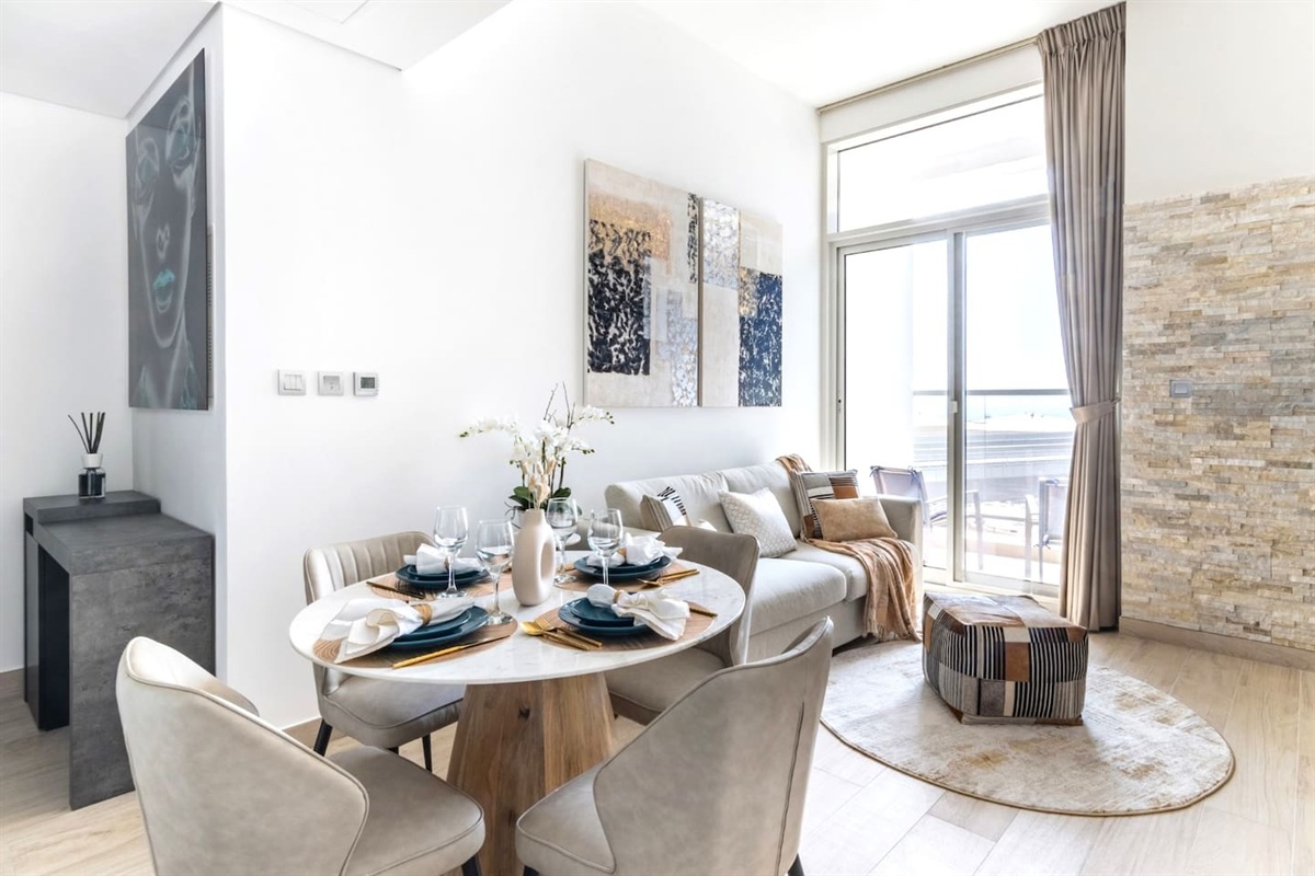 Living room with high end marble dining table and leather chairs