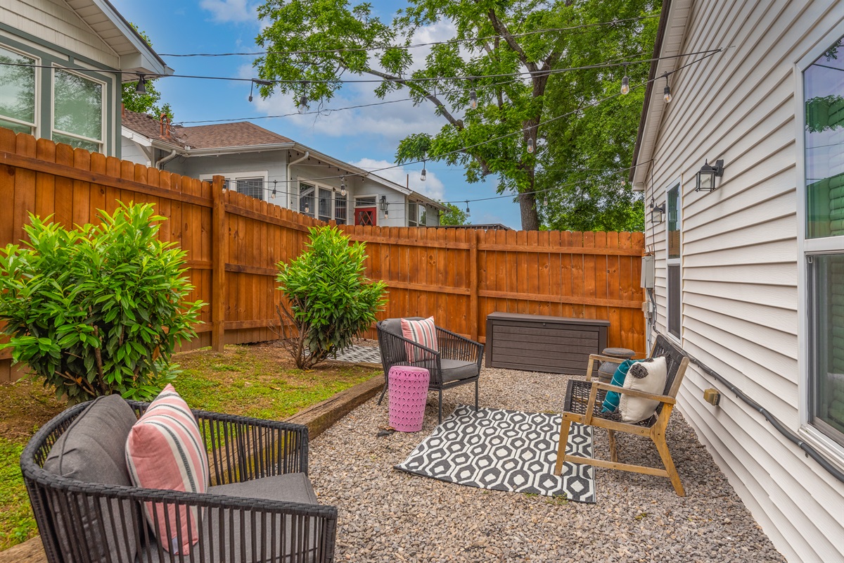 Outdoor lounge space with privacy fence.