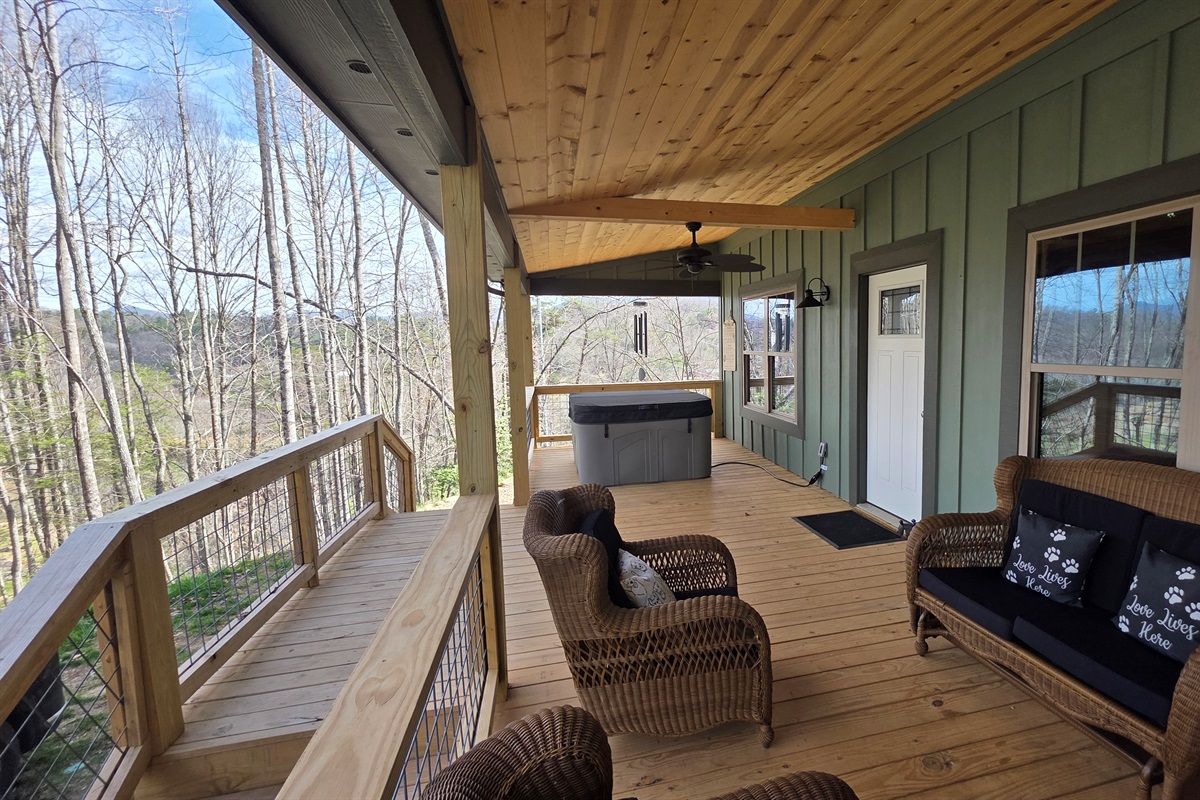 Large covered front porch with ceiling fans, private hot tub and rocking chairs.